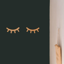 Load image into Gallery viewer, Cork lashes 3d sticker on a dark green wall.
