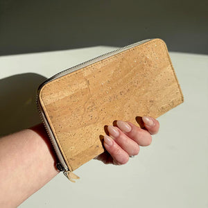 Hand holding our cork zipper purse