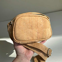 Load image into Gallery viewer, Hand holding the mini natural cork crossbody bag for size reference