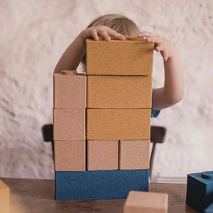 Toddler playing with the cork building blocks