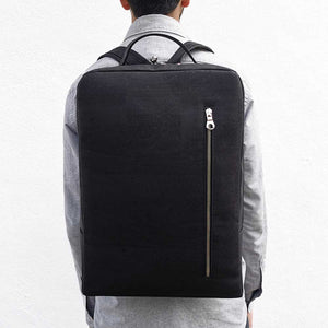 Model wearing a large black cork laptop backpack