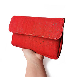 Red cork clutch crossbody bag on a hand