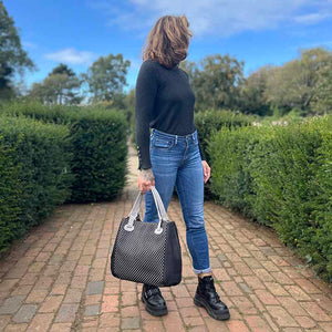 Model holding the large black and grey cork handbag with cut-outs