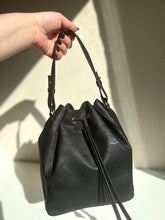 Load image into Gallery viewer, Classic black cork bucket bag with removable handle and adjustable and removable crossbody strap, natural light