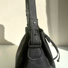 Load image into Gallery viewer, Classic black cork bucket bag with removable and adjustable crossbody strap and handle, handle detail