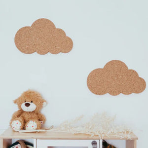 Two cork clouds on a wall of a child's room.