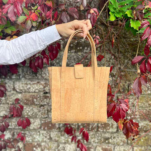 Model holding the natural cork handbag