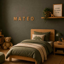 Load image into Gallery viewer, Children's bedroom with a bed, teddy bear, and decorative elements on a dark green wall with the cork letters spelling Mateo.