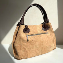 Load image into Gallery viewer, Natural and brown cork handbag with cut-outs, back view with zipper pocket detail