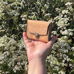 Small vegan natural cork purse with vintage style lock, natural light in models' hand