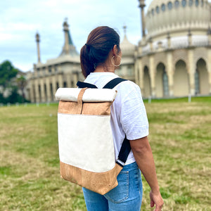 Model carrying our cork and canvas roll top backpack