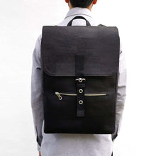 Load image into Gallery viewer, Model wearing a large black vegan cork leather backpack with folding top