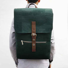 Load image into Gallery viewer, Model wearing a large green and brown vegan cork leather backpack with folding top