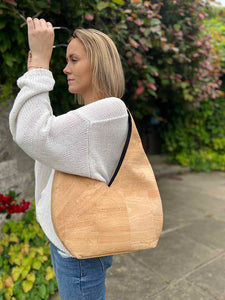 Model carrying the all natural cork hobo bag on her shoulder