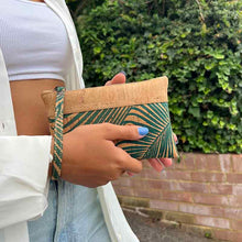 Load image into Gallery viewer, Model holding a natural cork wrist wallet with leaves print