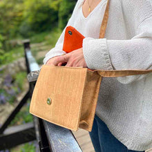 Load image into Gallery viewer, Model opens a natural, red and orange cork crossbody bag