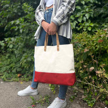 Load image into Gallery viewer, Model wearing a Red cork and canvas tote bag with natural cork handles