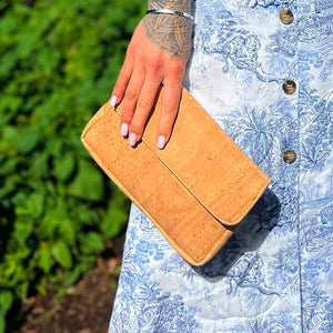 Model wearing a natural cork clutch crossbody bag