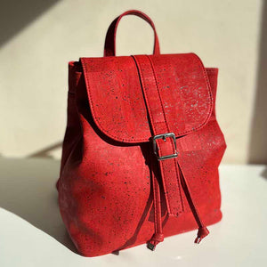 Red cork drawstring backpack with folding top in natural light